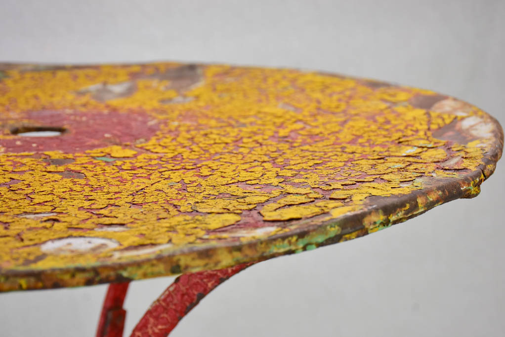 Early twentieth century bistro garden table with yellow and red patina