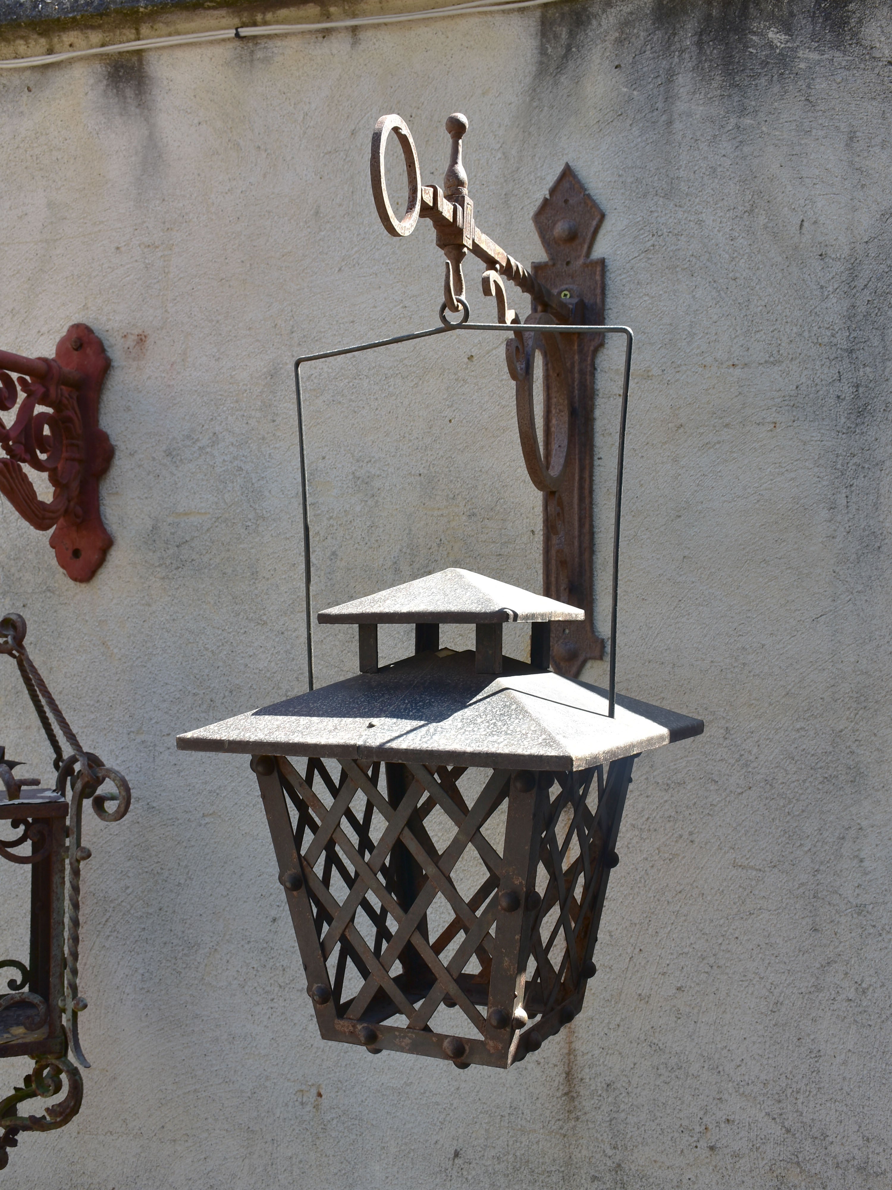 Pair of French wrought iron lanterns with wall brackets