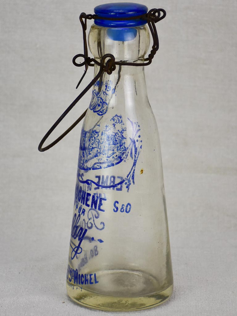 Antique French glass milk bottle with blue decoration