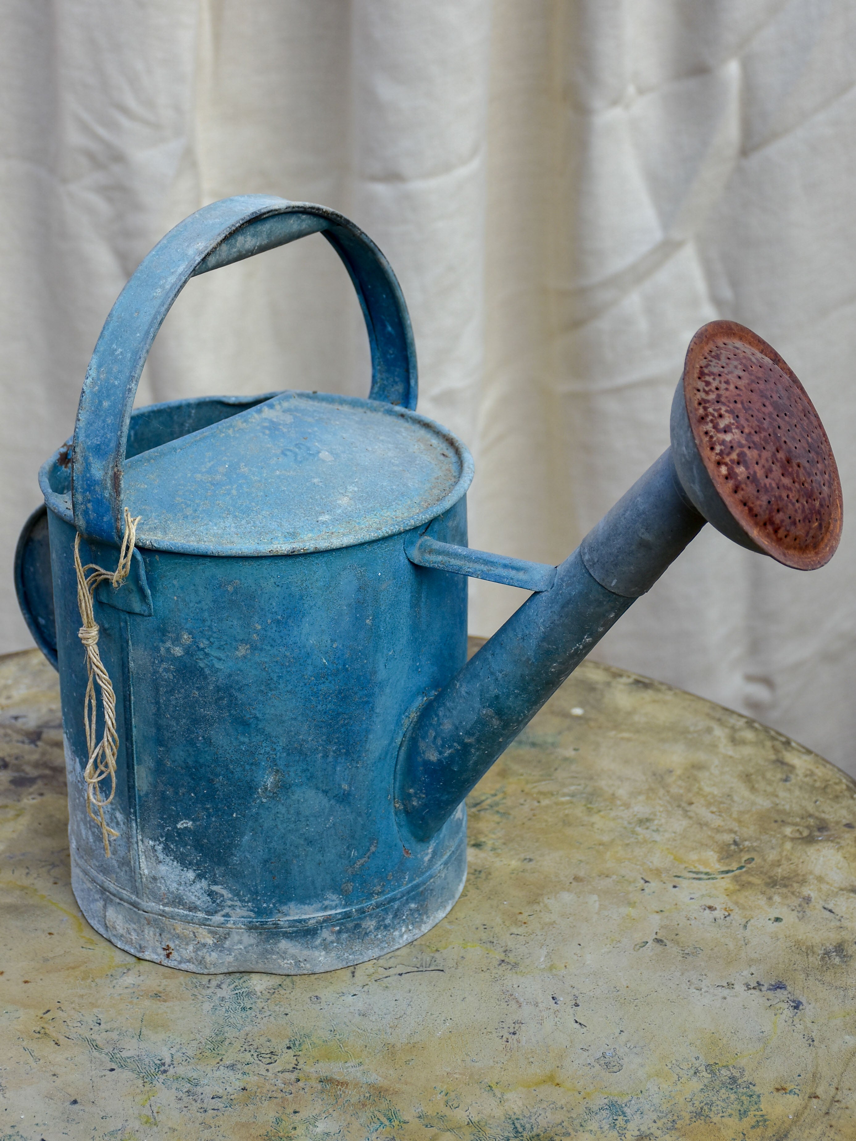 Antique French watering can with blue patina