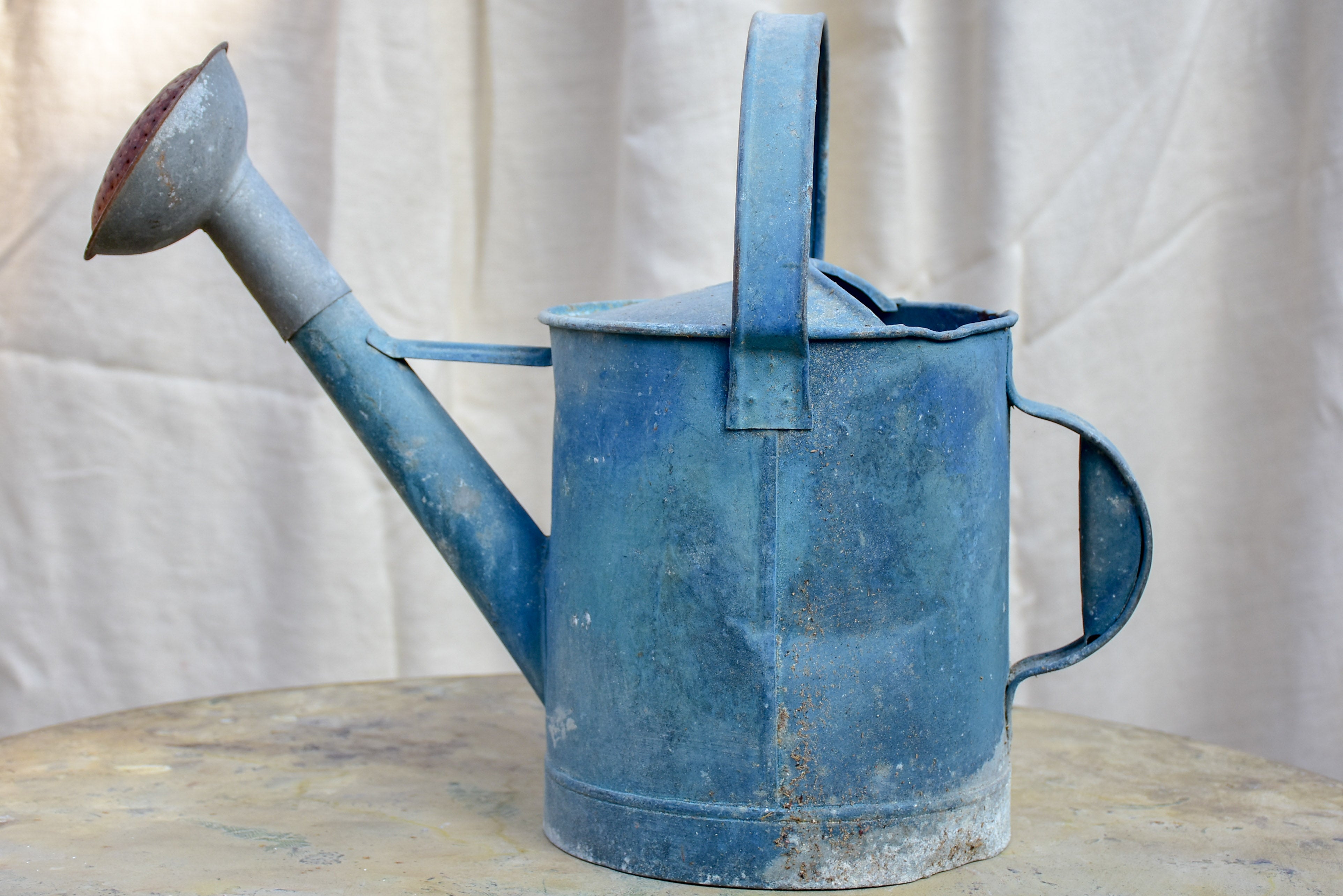 Antique French watering can with blue patina