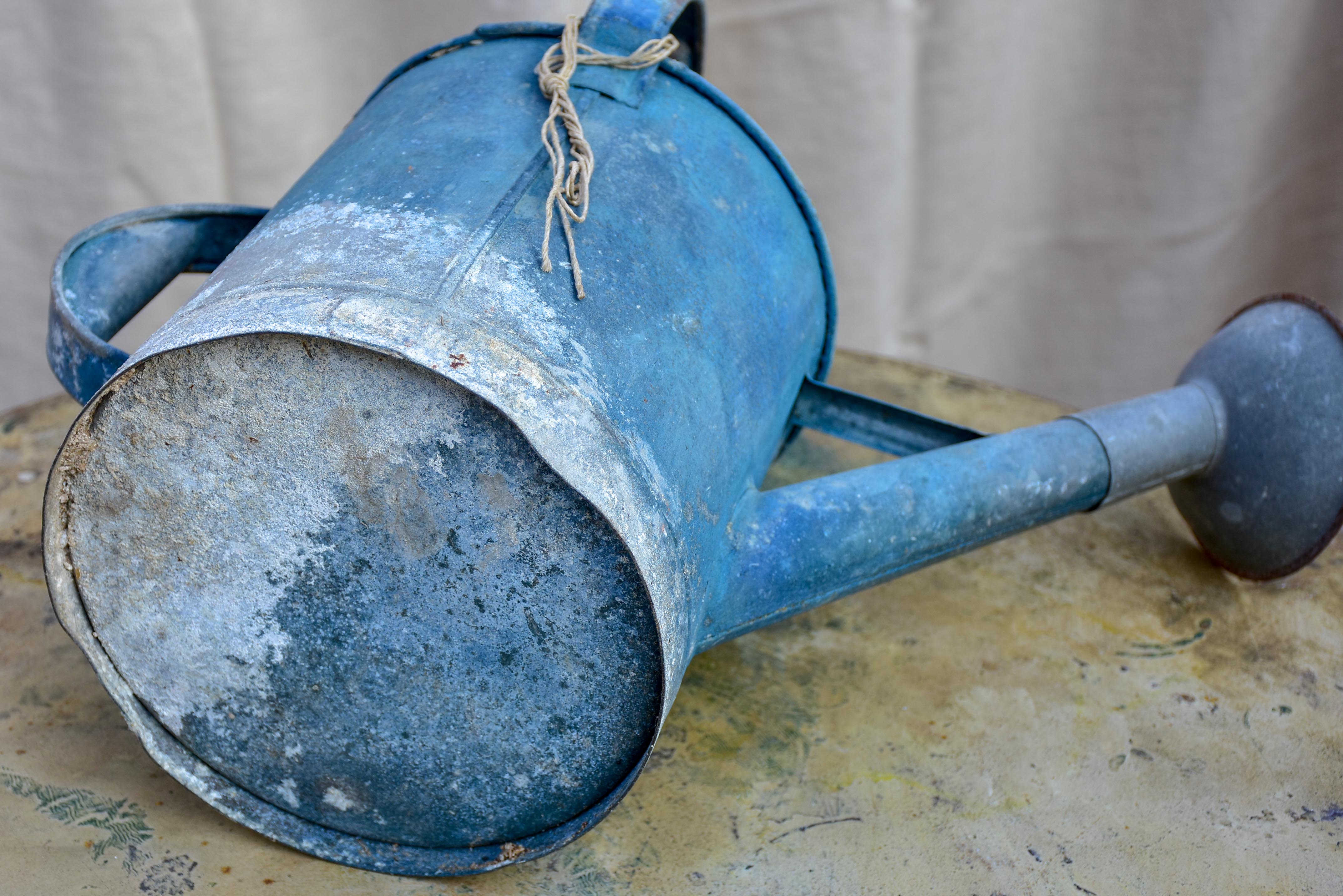 Antique French watering can with blue patina