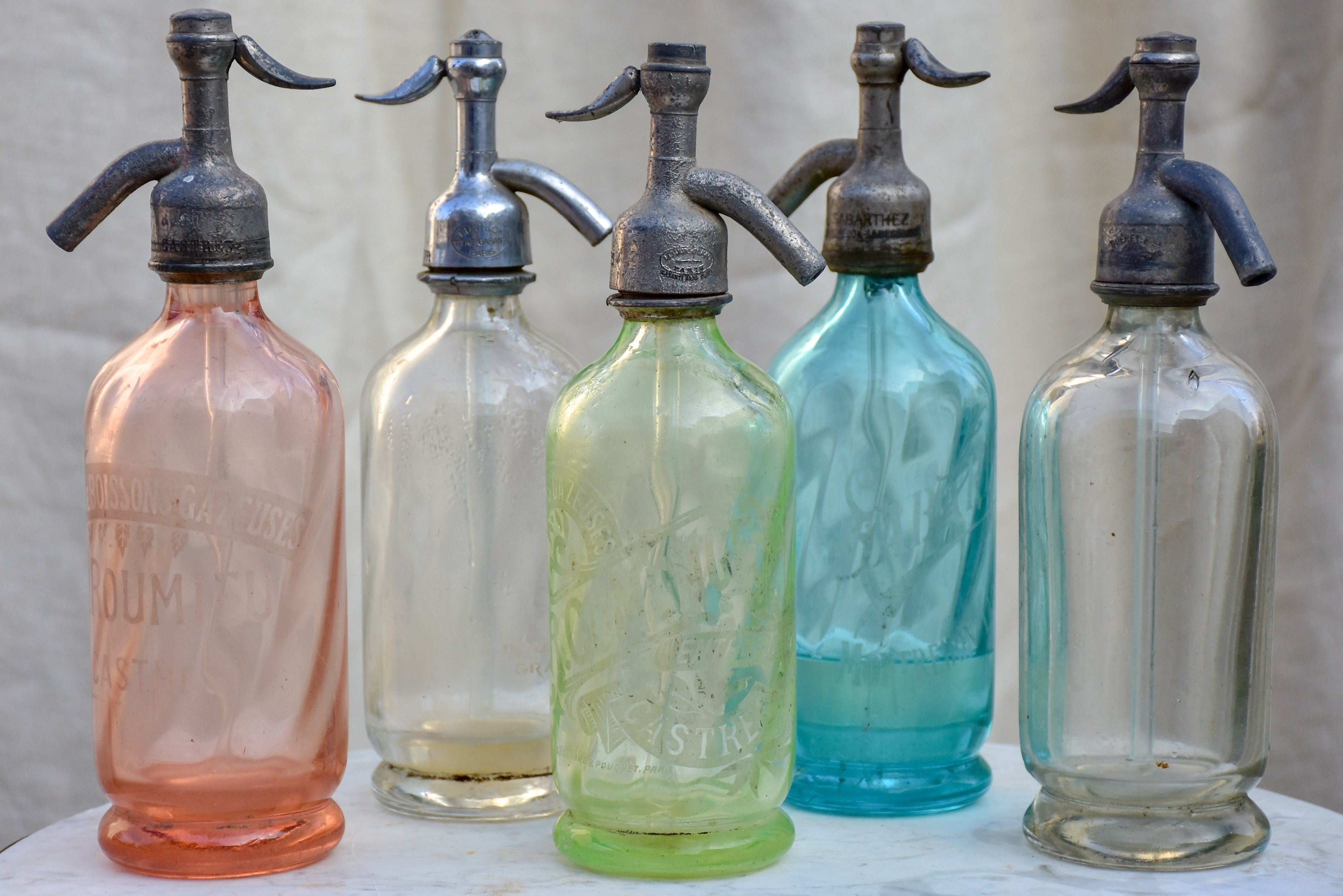 Collection of five antique French 'demi' seltzer bottles