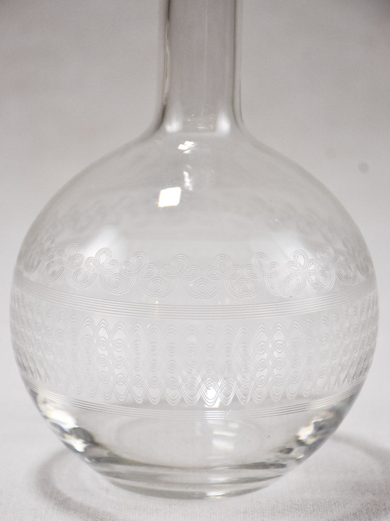 Vintage glass carafe with etched patterns