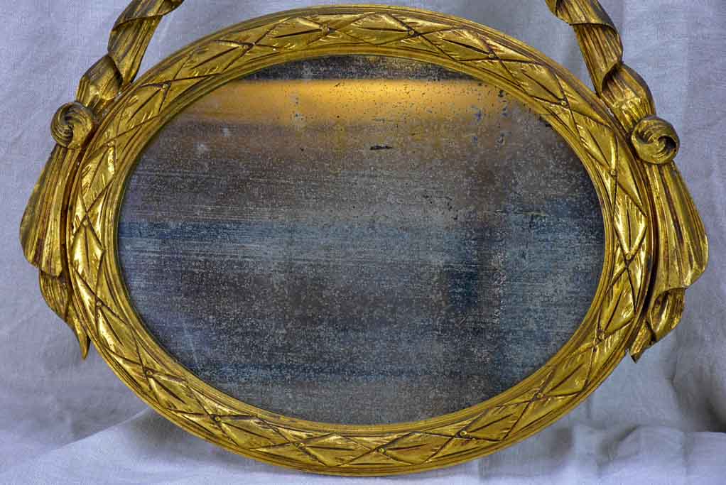 Pair of Louis XVI-style oval mirrors with carved wood frames 22" x 28¾"