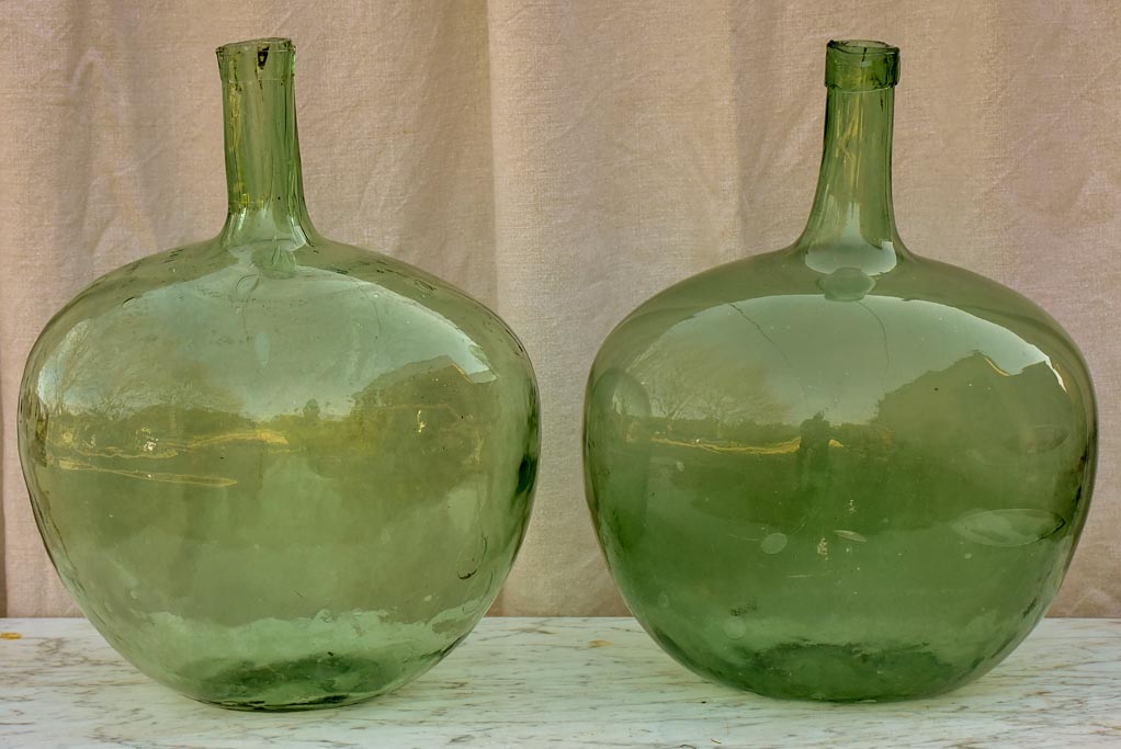 Two antique French demijohn bottles - oval blue green