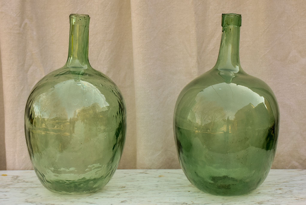 Two antique French demijohn bottles - oval blue green