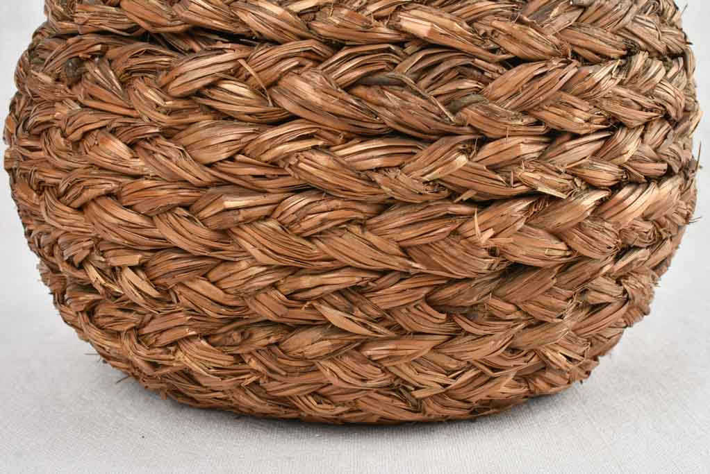 Small demijohn bottle in woven straw basket 11½"