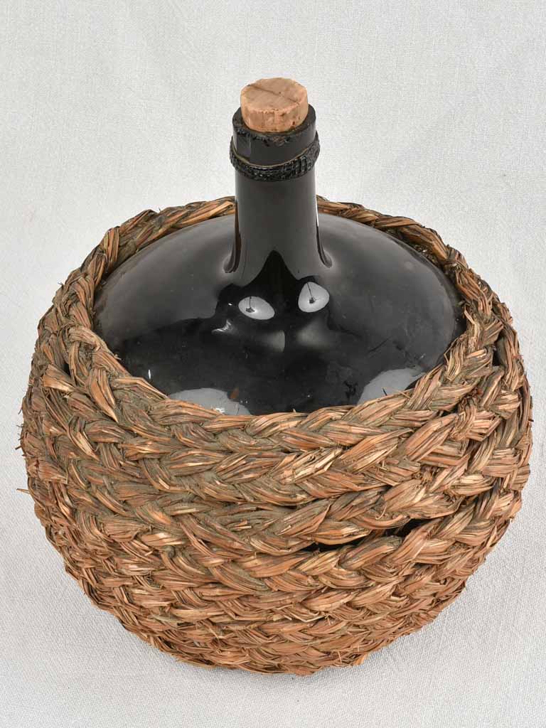 Small demijohn bottle in woven straw basket 11½"