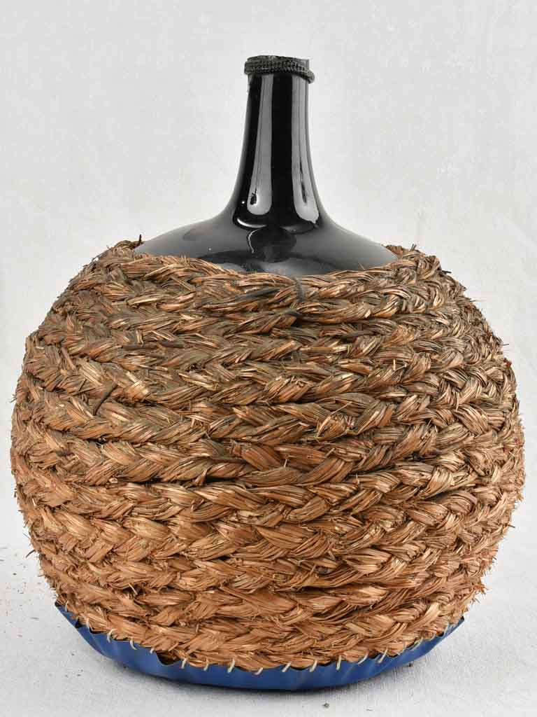 Large demijohn bottle in woven straw basket 15 ¾"