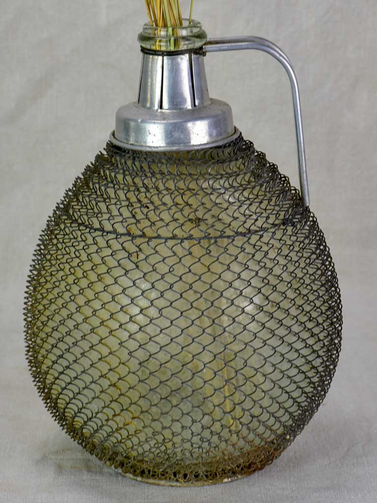 Mid century wine demijohn in mesh from Savoy 9""