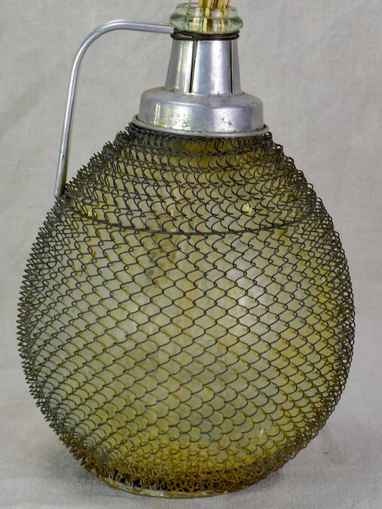 Mid century wine demijohn in mesh from Savoy 9""