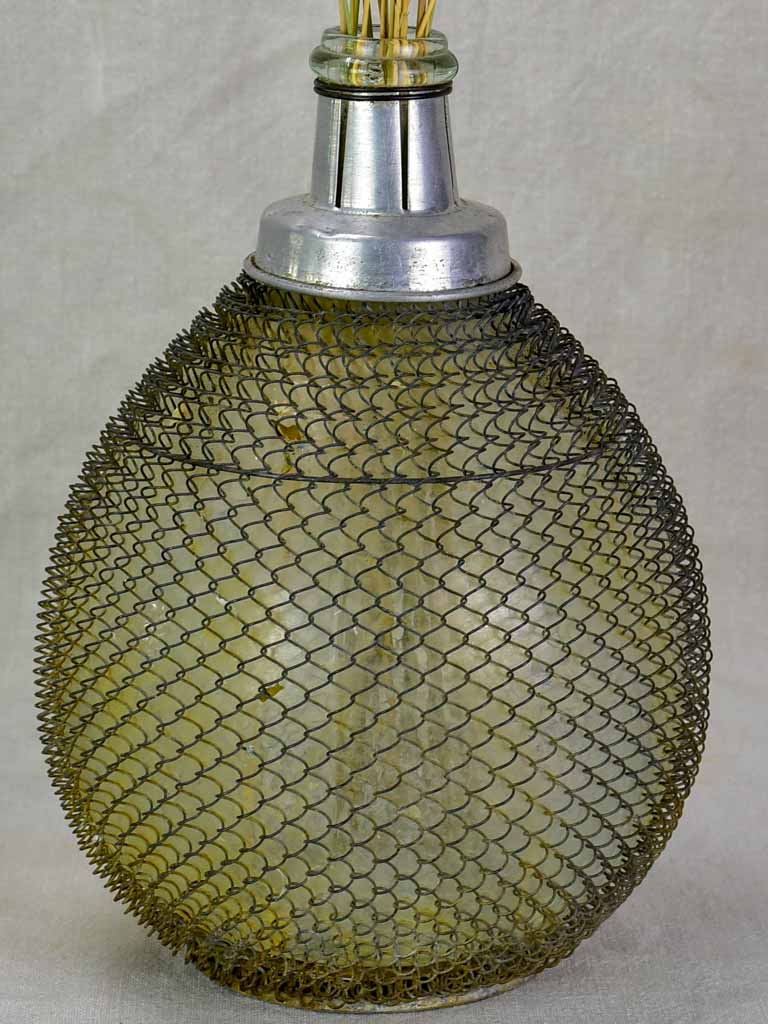 Mid century wine demijohn in mesh from Savoy 9""