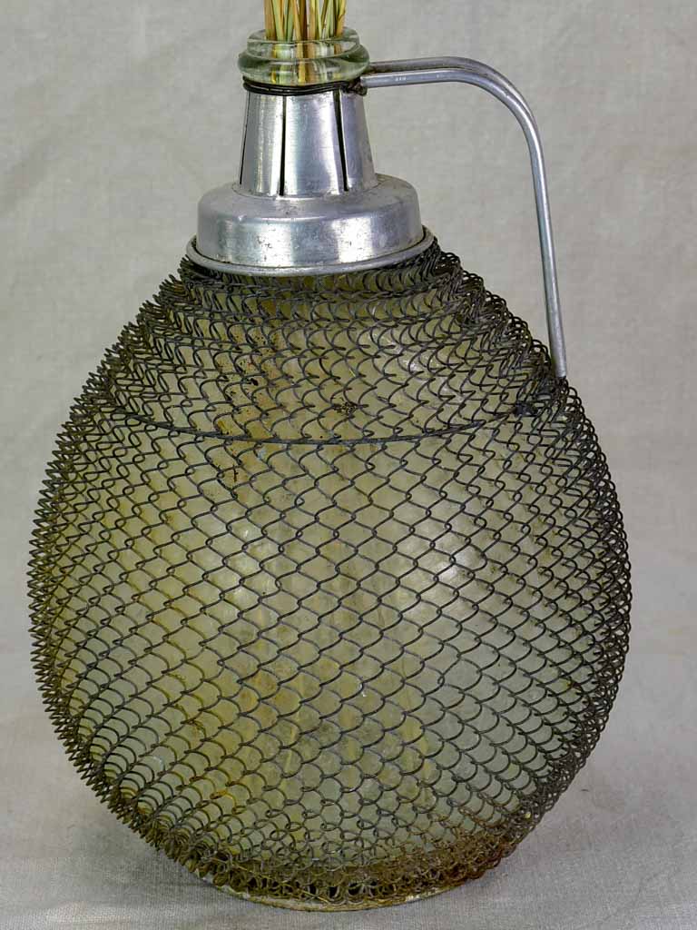 Mid century wine demijohn in mesh from Savoy 9""