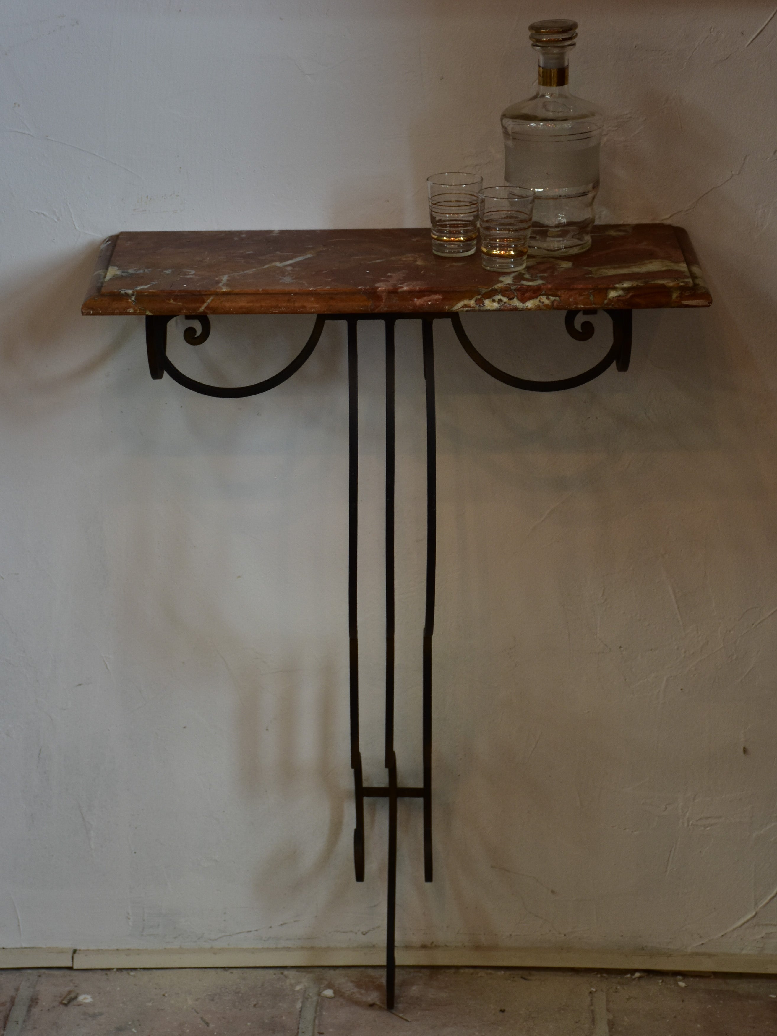 Small marble top console table with decorative wrought iron base