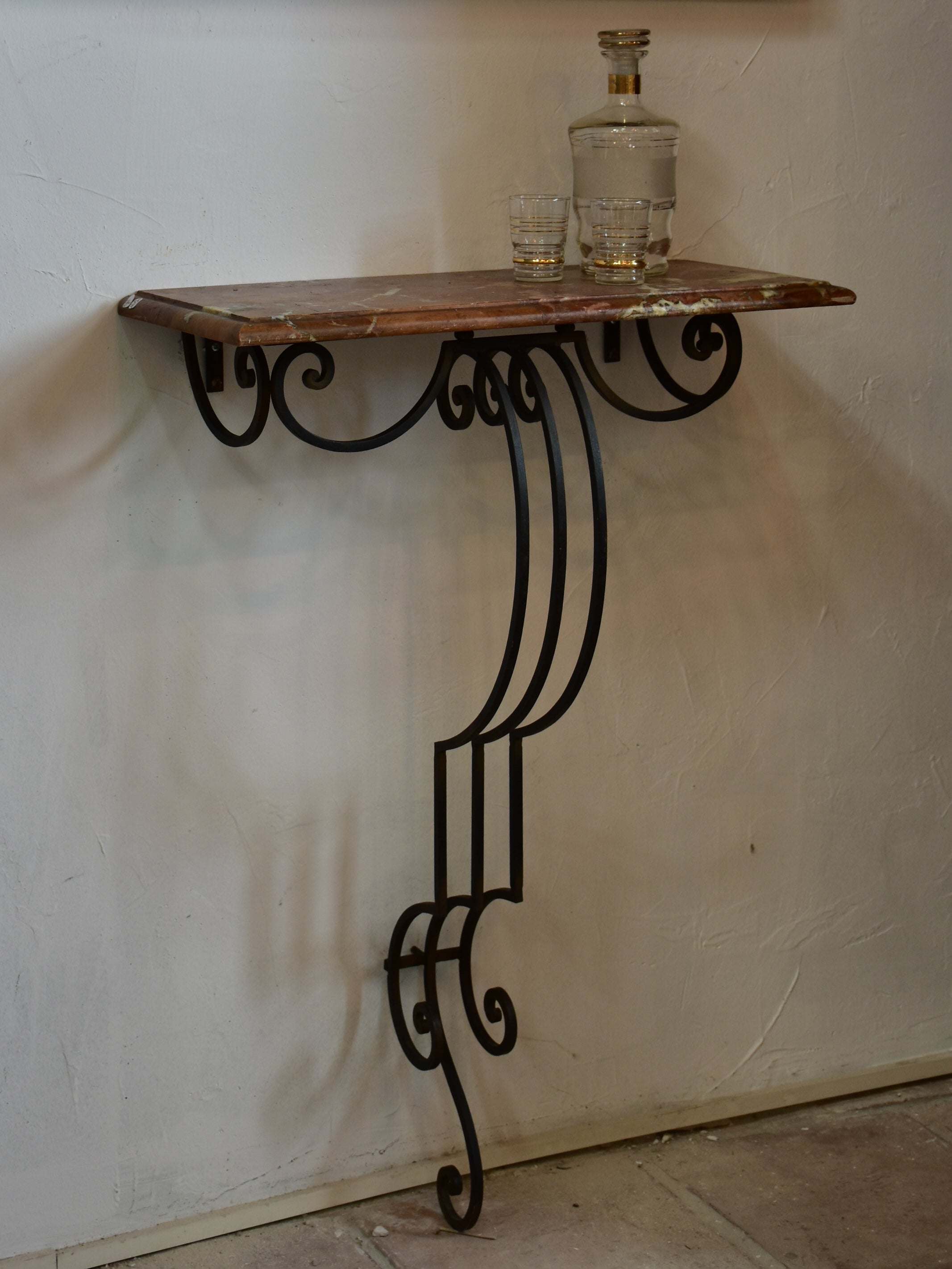 Small marble top console table with decorative wrought iron base