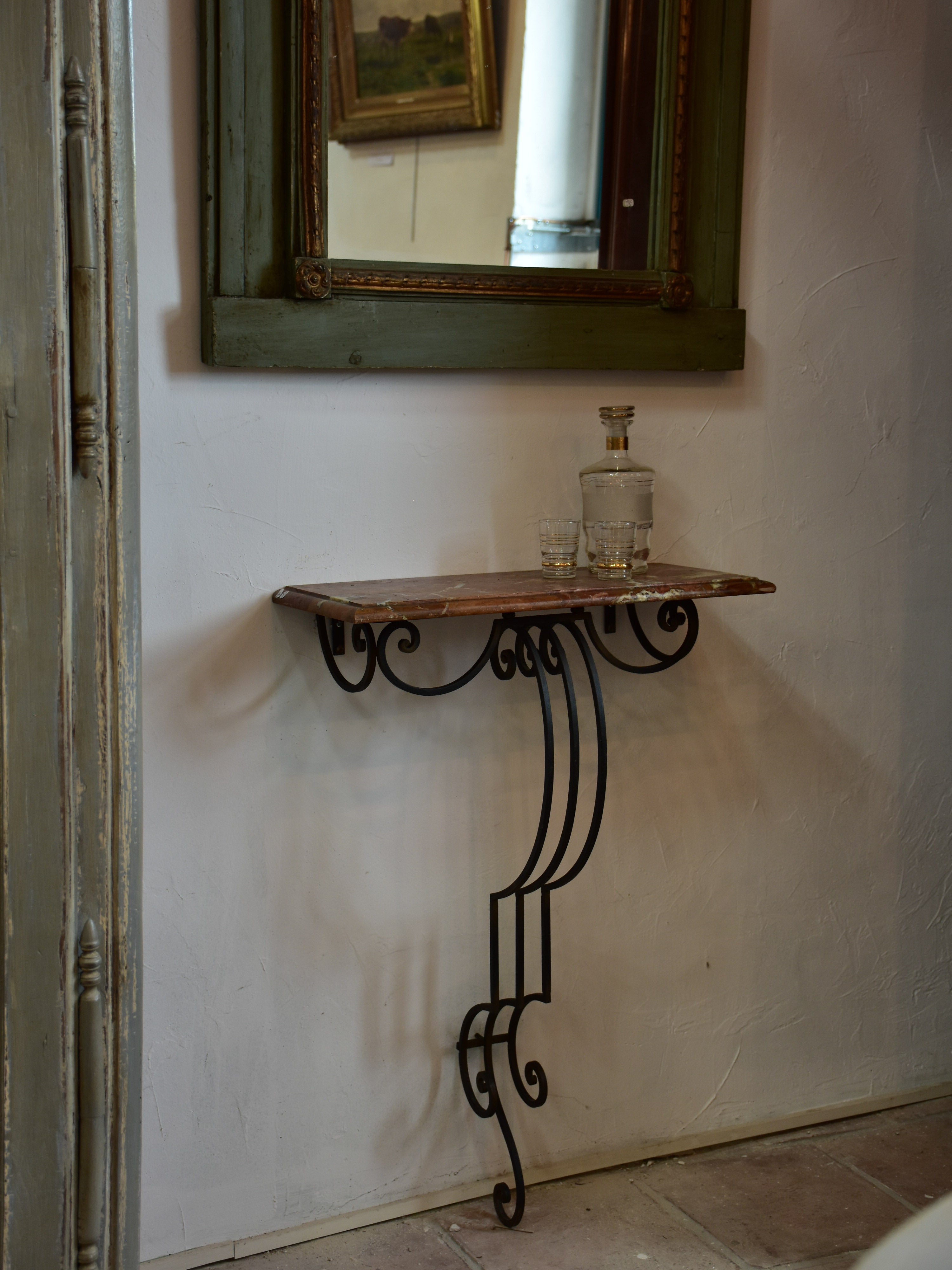 Small marble top console table with decorative wrought iron base