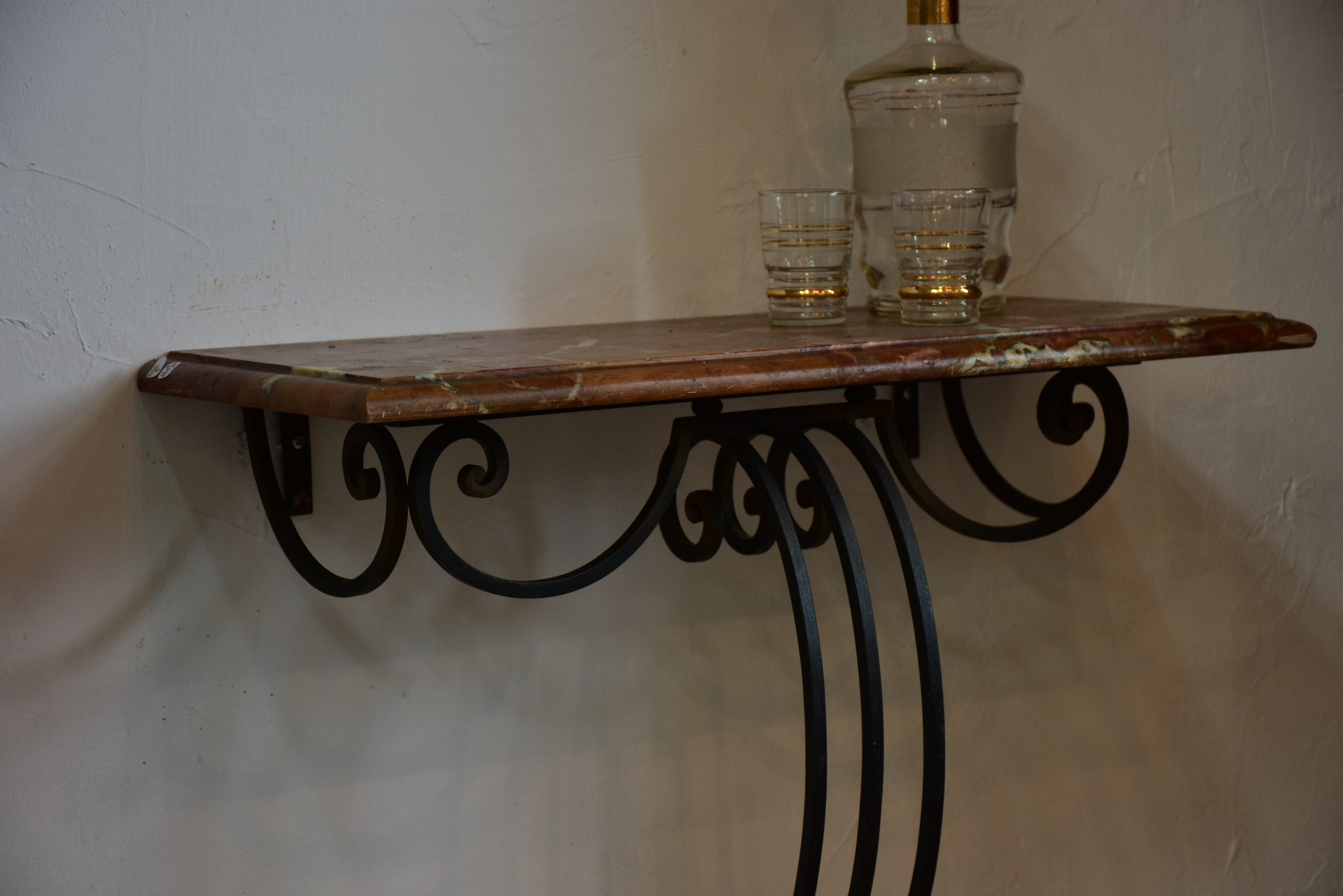 Small marble top console table with decorative wrought iron base