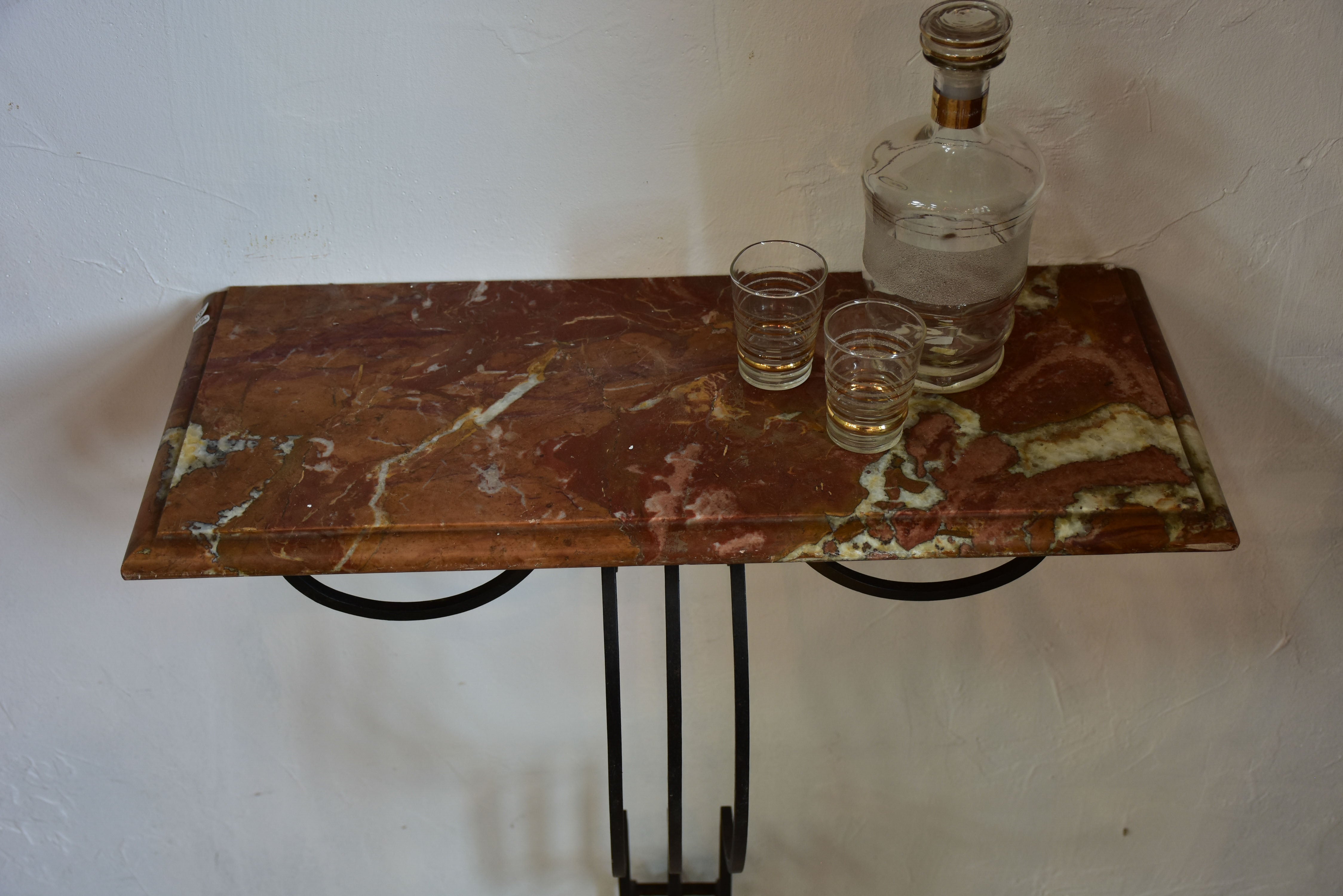 Small marble top console table with decorative wrought iron base