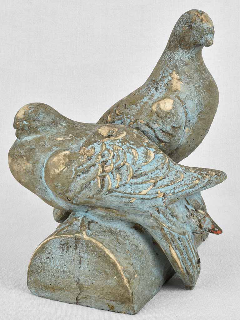 Vintage garden sculpture of two pigeons on a log