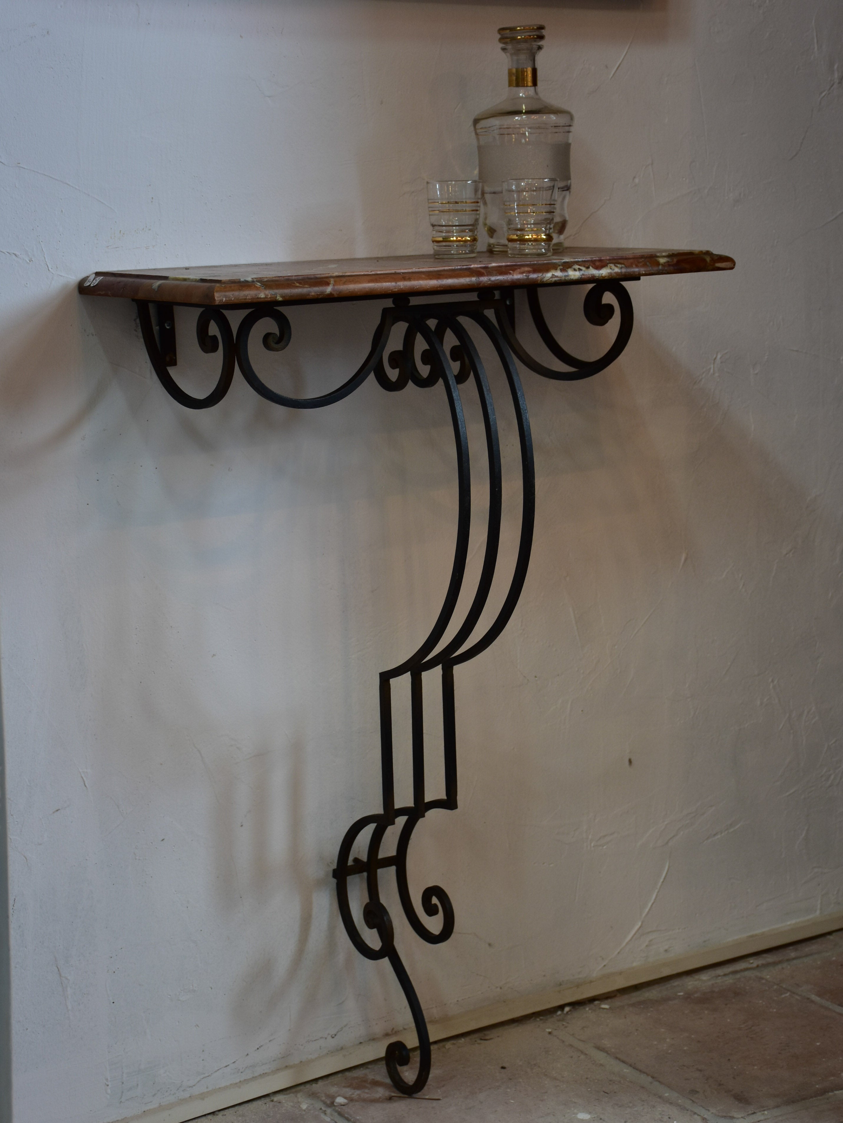 Small marble top console table with decorative wrought iron base