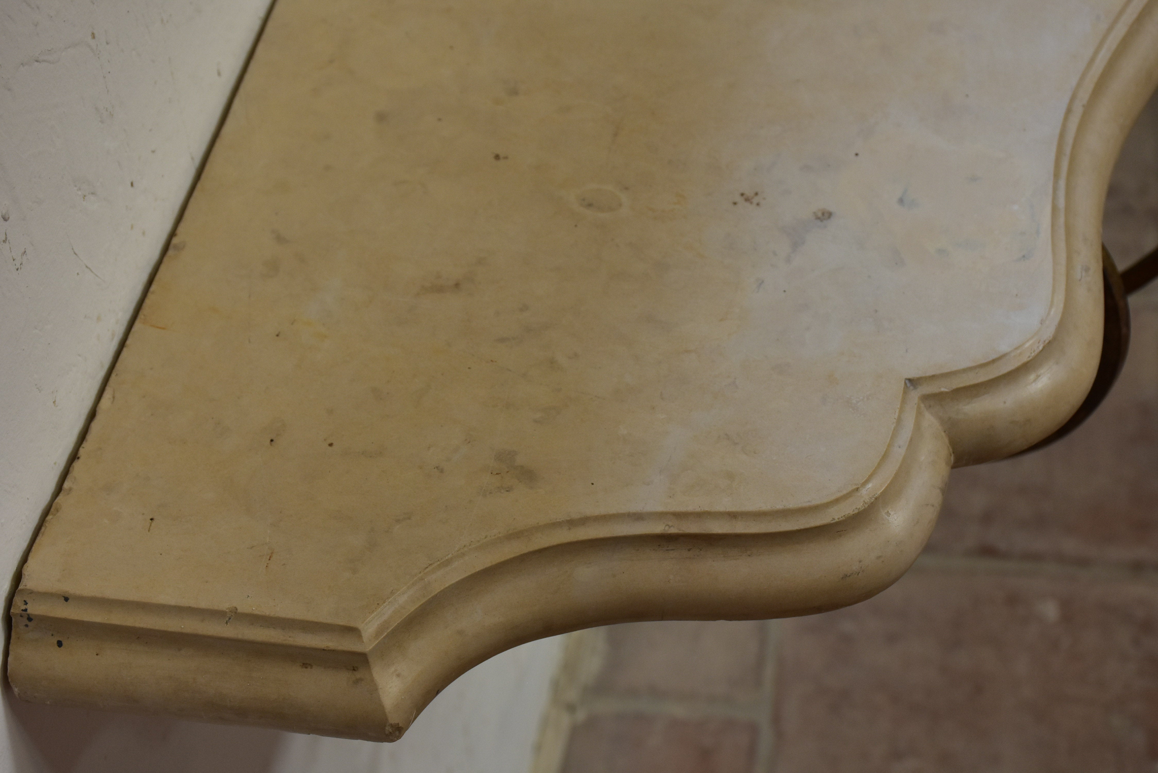 Floating console table with cream marble top and decorative iron base