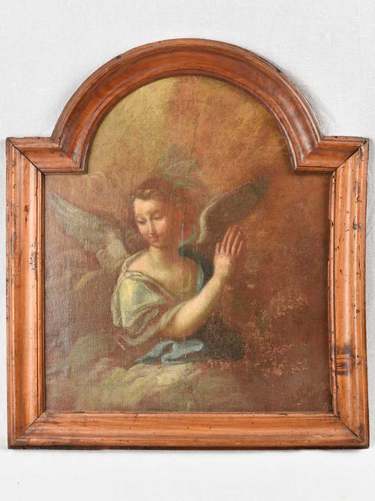 17th century painting of an angel in prayer in arched wooden frame 24" x 27¼"