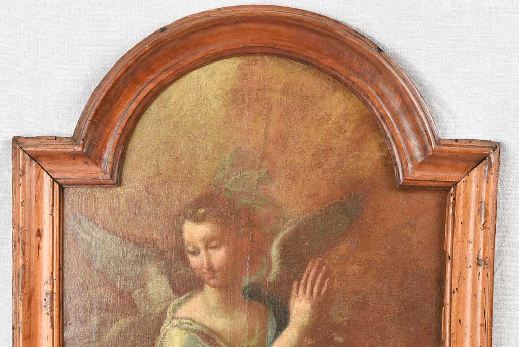 17th century painting of an angel in prayer in arched wooden frame 24" x 27¼"