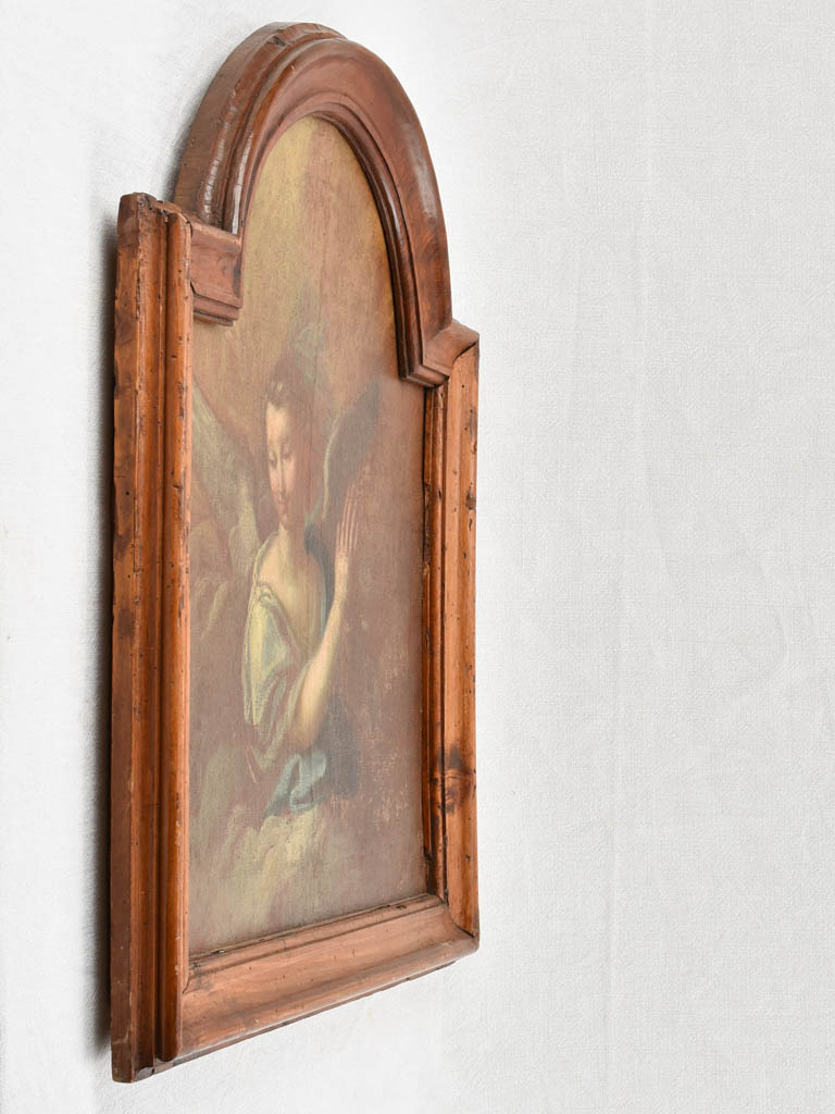 17th century painting of an angel in prayer in arched wooden frame 24" x 27¼"