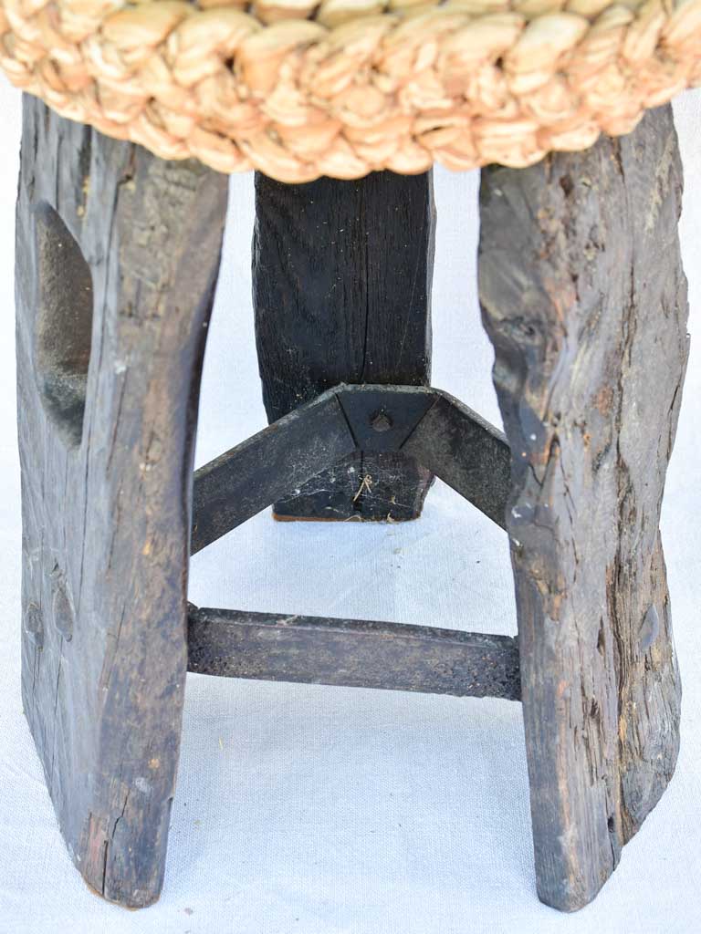 Three 1960's stools with woven seats and weighty timber and iron bases