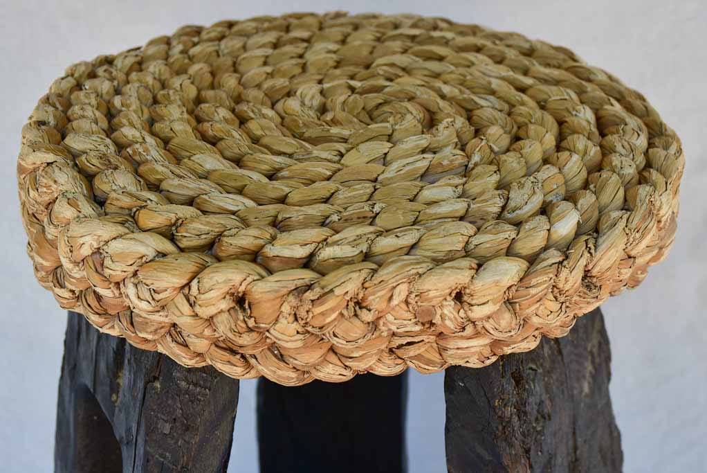 Three 1960's stools with woven seats and weighty timber and iron bases