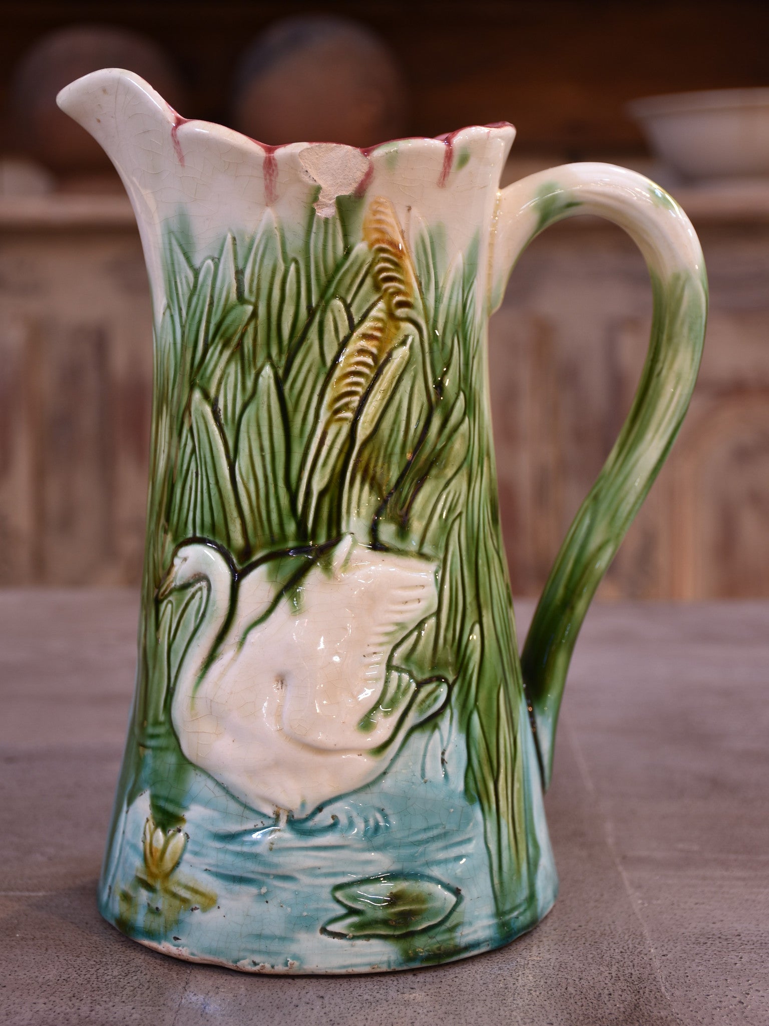 Antique Barbotine Majolica jug with bathing swans