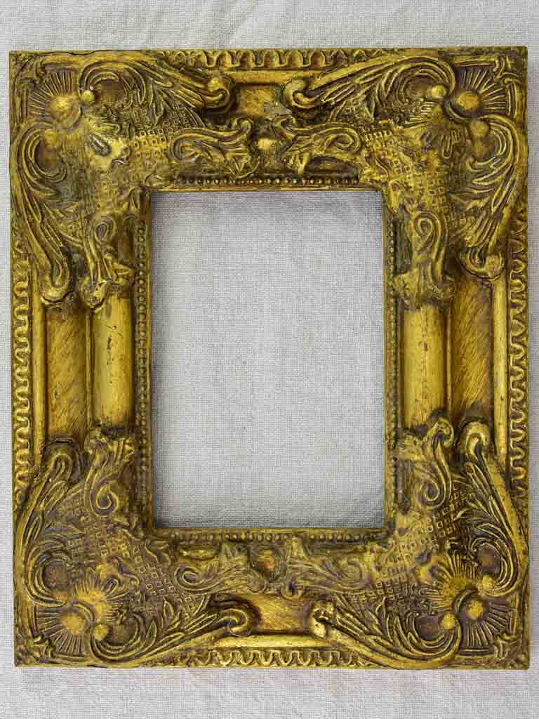 Timber and stucco frame with gold patina