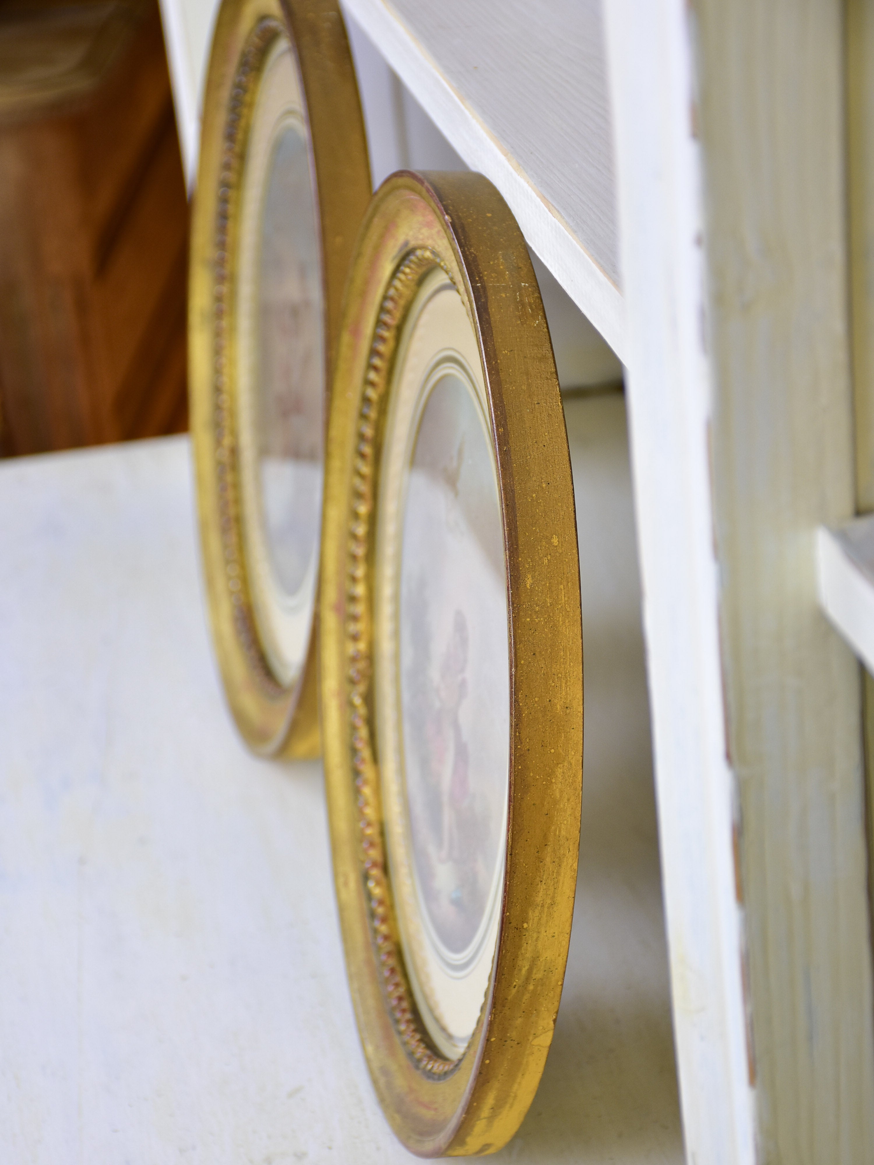 A pair of 19th century French paintings in oval frames