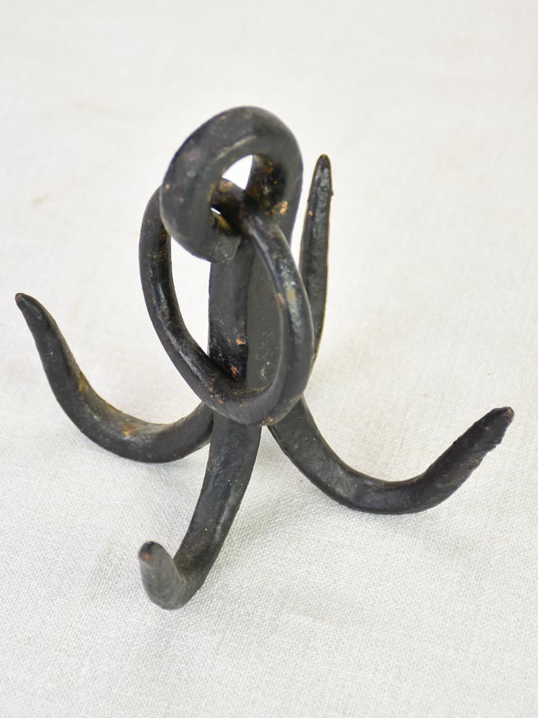 Weighty iron hooks from a water well