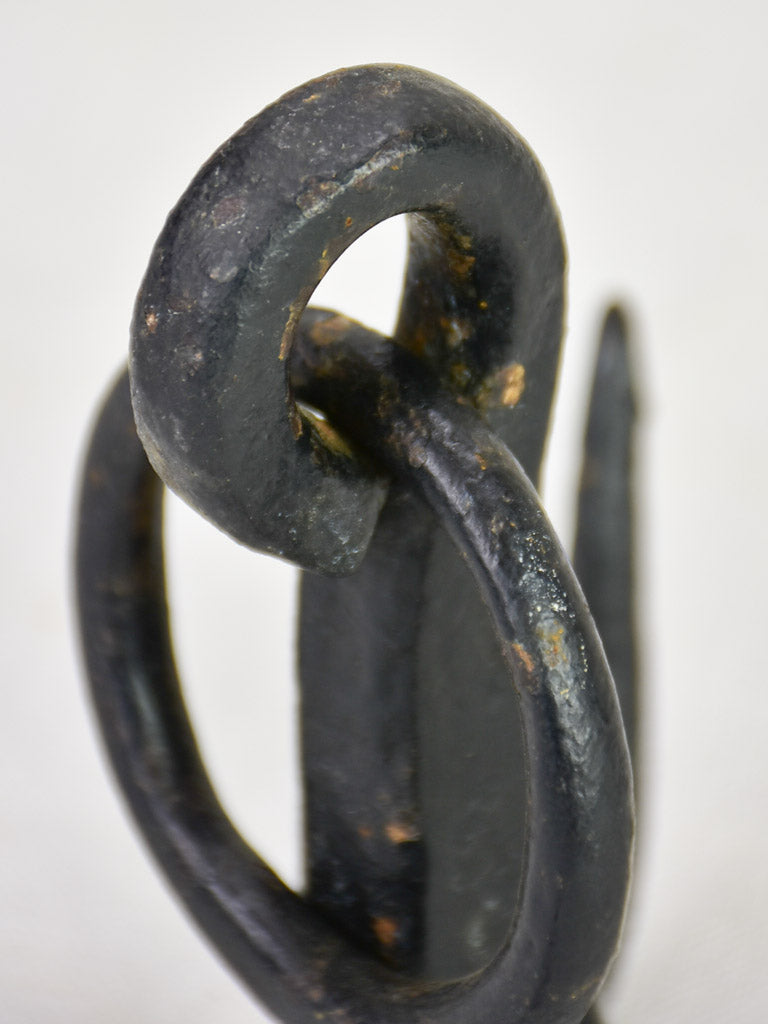 Weighty iron hooks from a water well