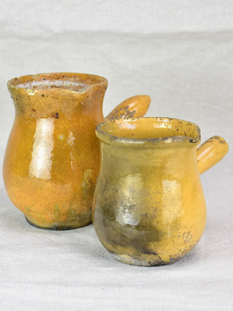 Two small antique French sauce pitchers with side handles