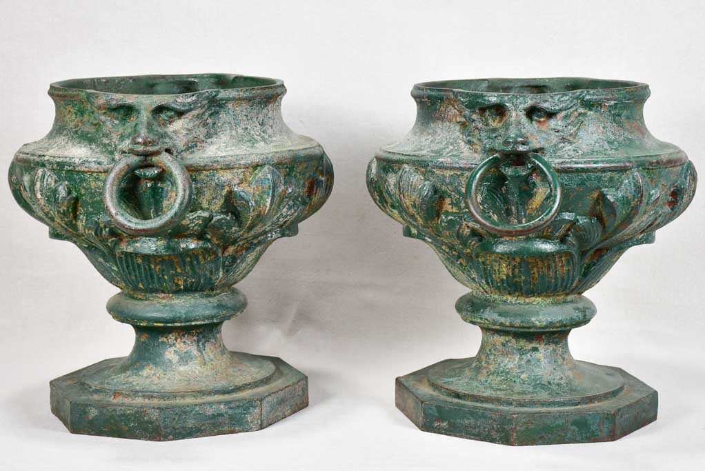 Pair of cast iron garden urns with green patina