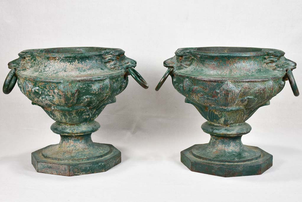 Pair of cast iron garden urns with green patina