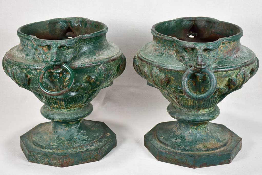 Pair of cast iron garden urns with green patina