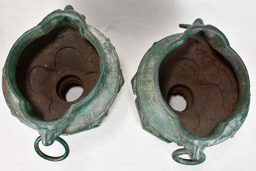 Pair of cast iron garden urns with green patina