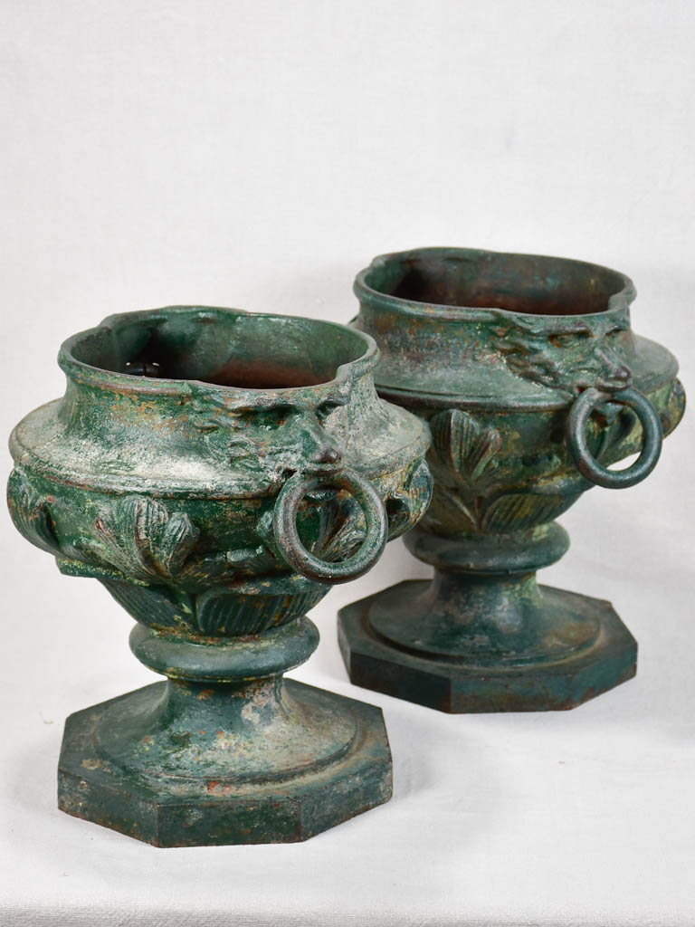 Pair of cast iron garden urns with green patina