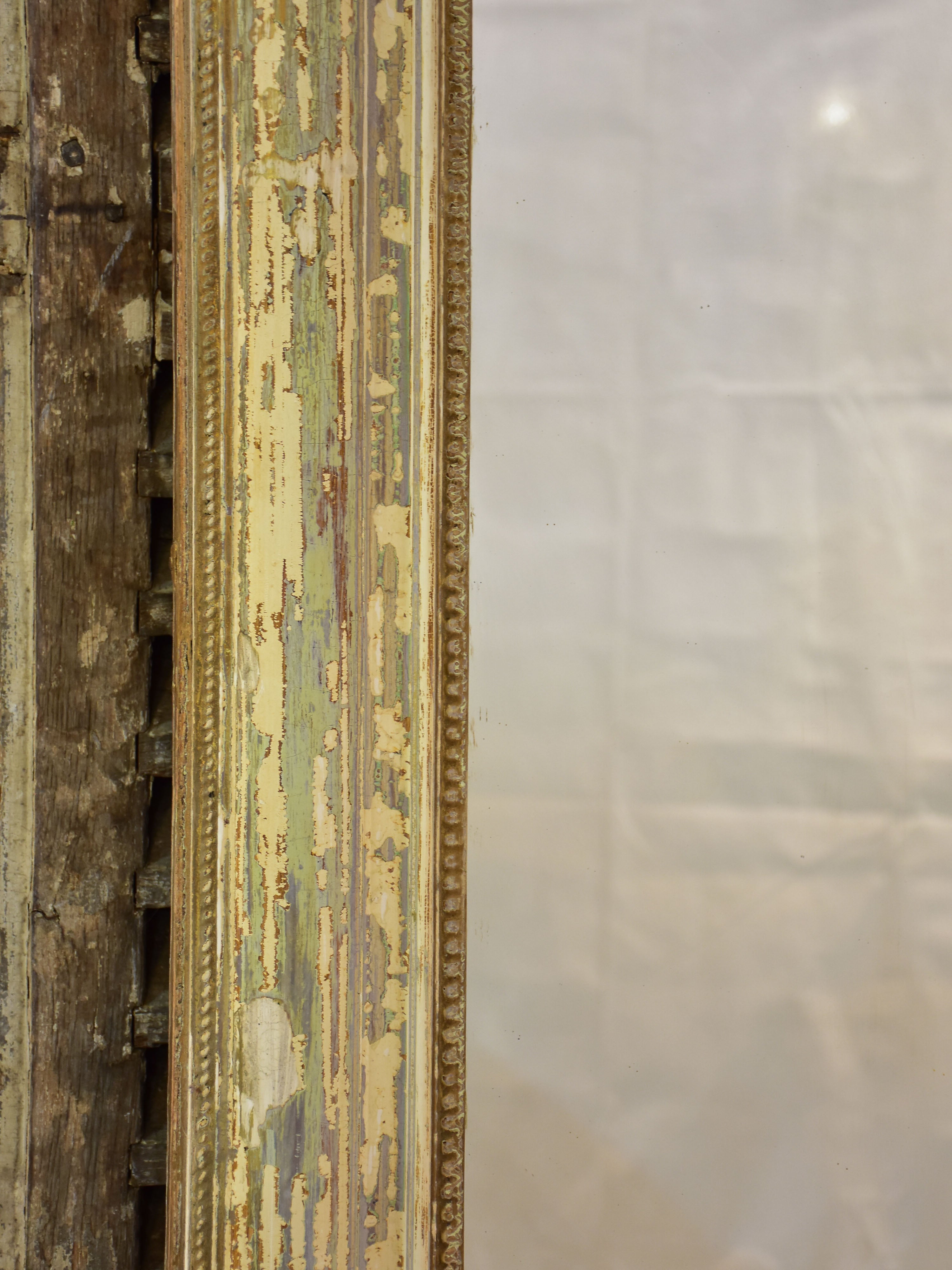 Large 19th century Louis XVI mirror with patinated frame