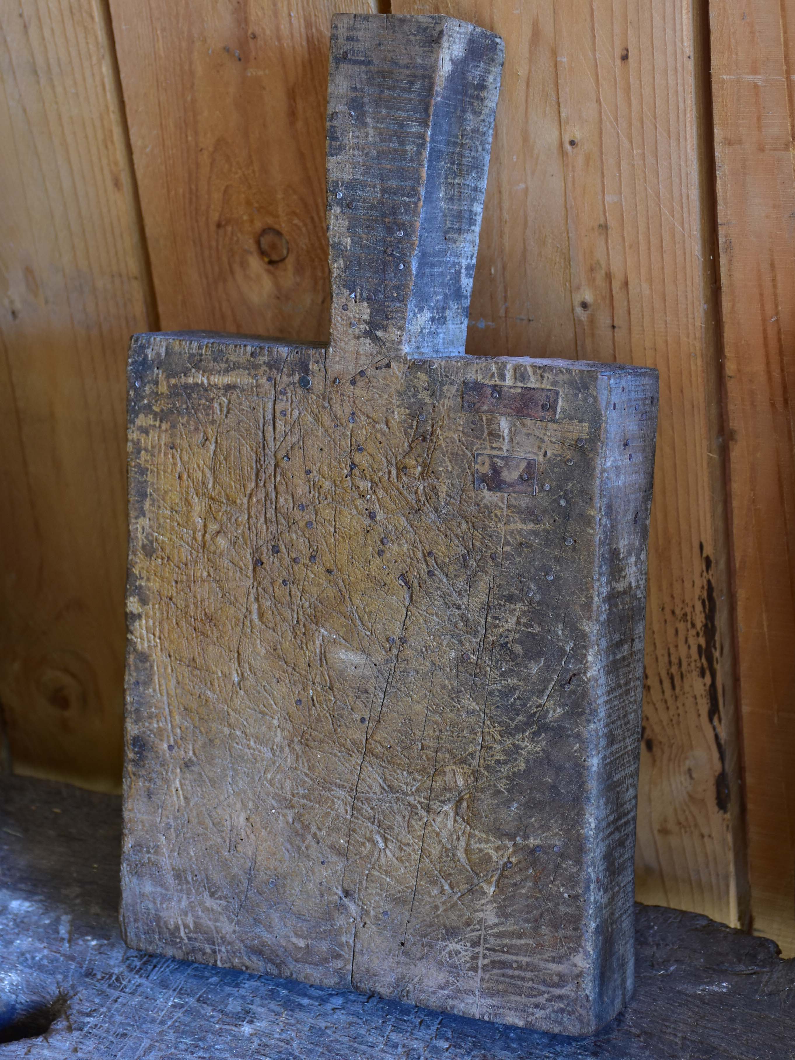 Very chunky antique French cutting board with triangular handle