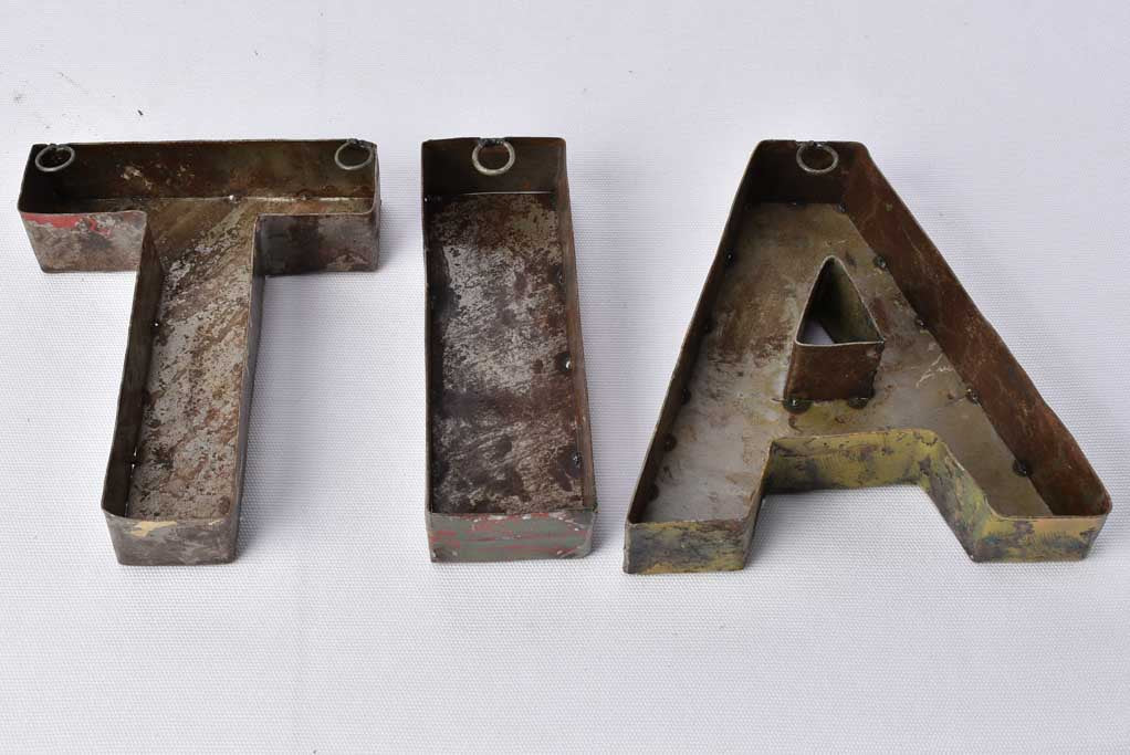 Weathered steel, vintage appeal lettering artifacts