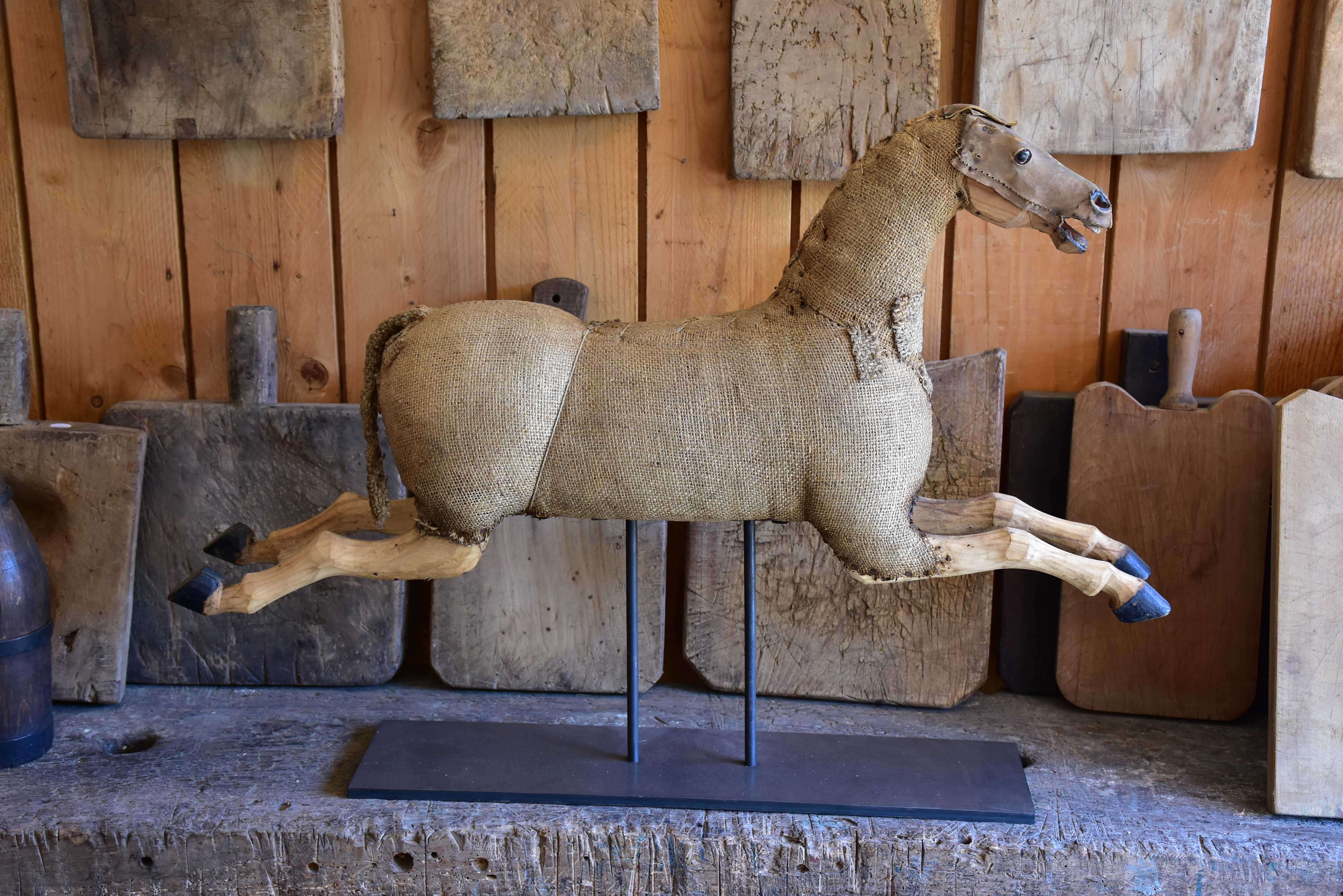 Antique French toy horse mounted on a stand