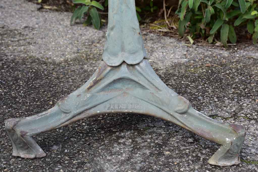 Art Nouveau cast iron bistro table with beige glass table top