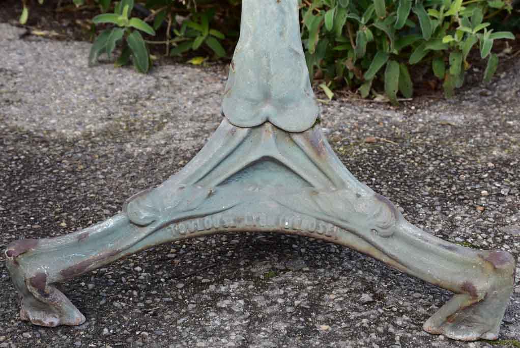 Art Nouveau cast iron bistro table with beige glass table top