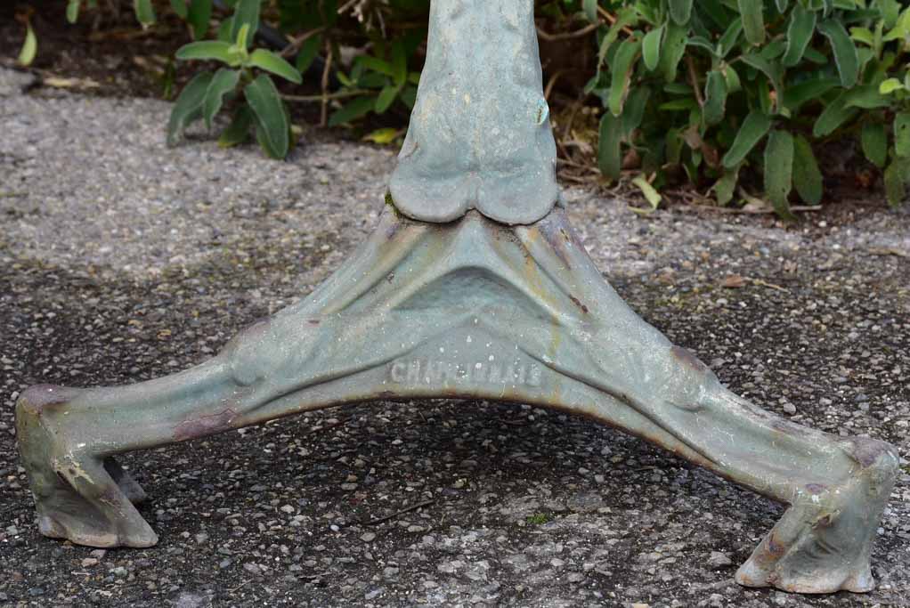 Art Nouveau cast iron bistro table with beige glass table top