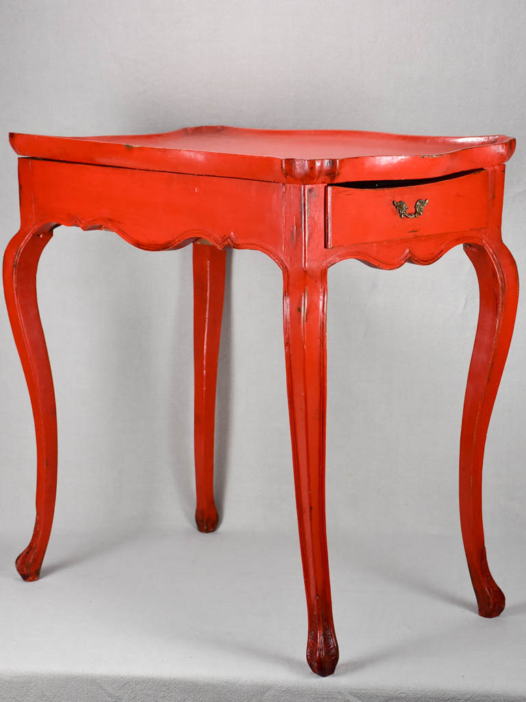 Louis XV table with side draw and red paint finish